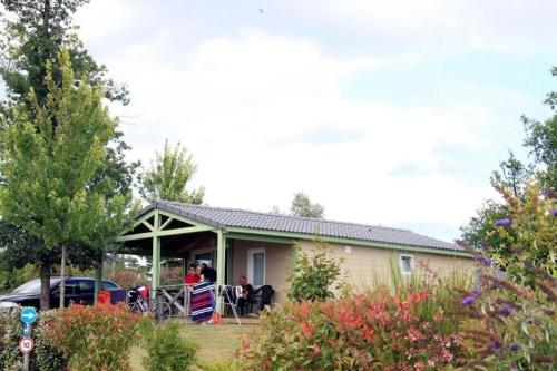 a group of people sitting on the porch of a house at Chalet 3 étoiles - Piscine - eebbhf in Beynat