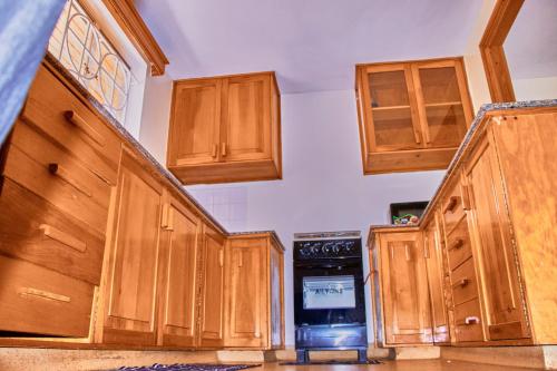 a kitchen with wooden cabinets and an oven at The Haven House in Nairobi