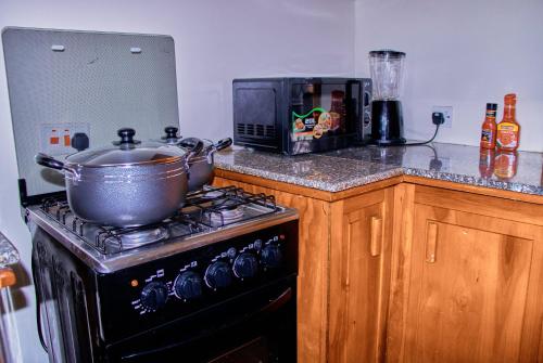 a kitchen with a stove with a pot on top of it at The Haven House in Nairobi
