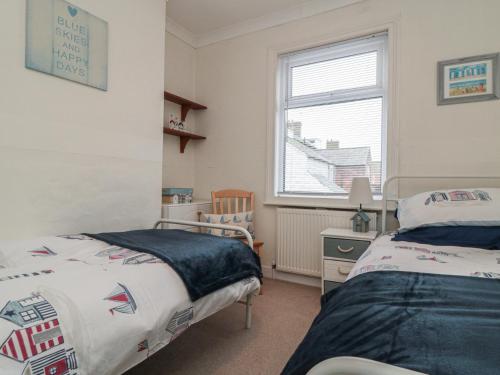 a bedroom with two beds and a window at Seabreeze in Filey