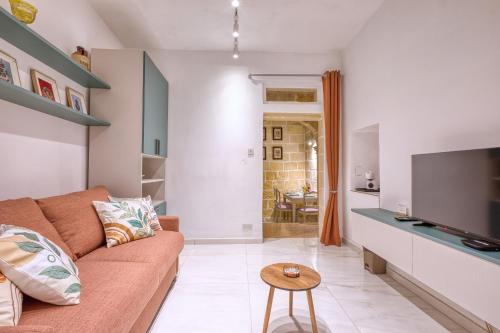 a living room with a couch and a tv at Beautiful traditional townhouse in the heart of Rabat AMIF2-1 in Rabat