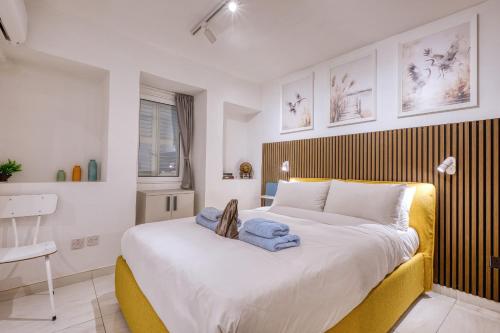 a bedroom with a large bed with a yellow headboard at Beautiful traditional townhouse in the heart of Rabat AMIF2-1 in Rabat
