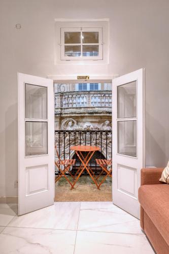 a room with two doors with a table in the background at Beautiful traditional townhouse in the heart of Rabat AMIF2-1 in Rabat
