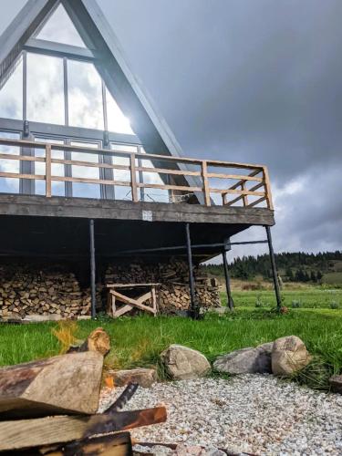 a building with a deck on top of some rocks at У Потічка in Izki