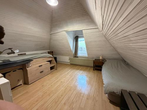 a bedroom with a bed and a sink in a room at Gite des Trévignes in Cambremer