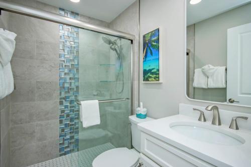 a bathroom with a toilet and a sink and a shower at Sandalfoot 5D3 - Oceanfront Sanibel Condo in Sanibel