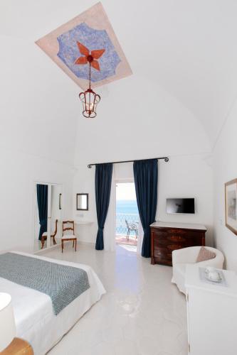 a bedroom with a bed and a view of the ocean at La Bizantina Luxury Villa in Positano