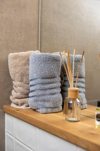 a pile of towels sitting on a counter in a bathroom at Pula Residence in Pula