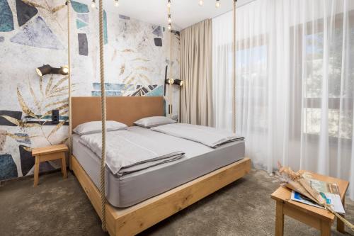 a bedroom with a swing bed in a room at Pula Residence in Pula