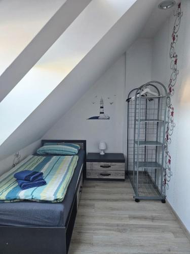 a bedroom with a bed and a ladder in a attic at Ferienhaus Lilja mit Grill Kamin eignes großes Grundstück und Außenpool in Trzęsacz