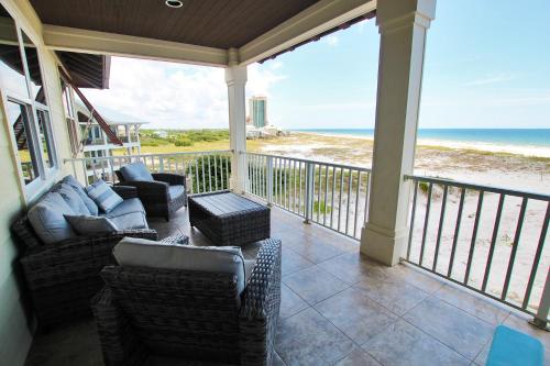 a porch with couches and chairs and the ocean at Summer Salt 3 East by Youngs Suncoast in Orange Beach