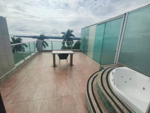 a balcony with a table and a bath tub on a building at Hotel Vale Do Xingu in Altamira