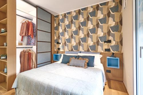 a bedroom with a bed and a wall with patterns at À la plage B in San Benedetto del Tronto