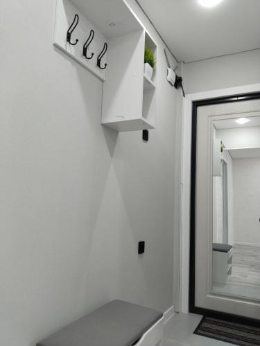 a white bathroom with a sink and a mirror at Абая in Temirtaū
