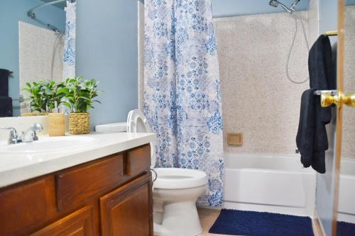 a bathroom with a sink and a toilet and a shower at Exclusive 2B1B Prime Location in Sylvan Lake