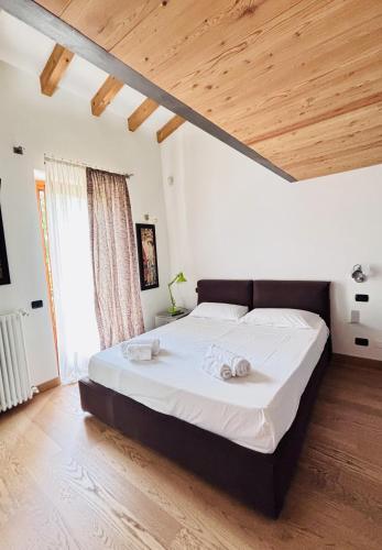 a bedroom with a large bed with two towels on it at Lazise Suite in Lazise