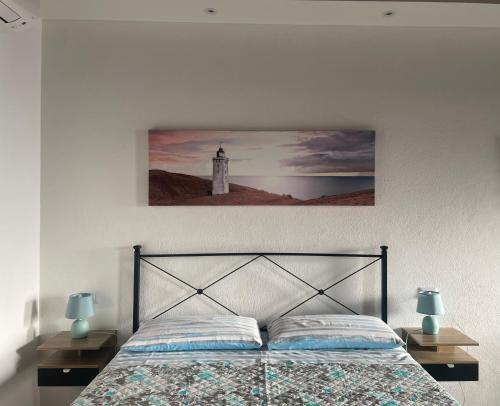 a bedroom with a bed with two lamps and a lighthouse at Antico Borgo in Ancona