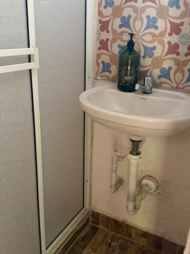 a bathroom sink with a bottle on top of it at ecopolis birds lodge in El Queremal