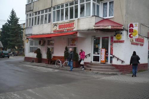 a couple of people standing outside of a restaurant at Király Apartman in Gheorgheni
