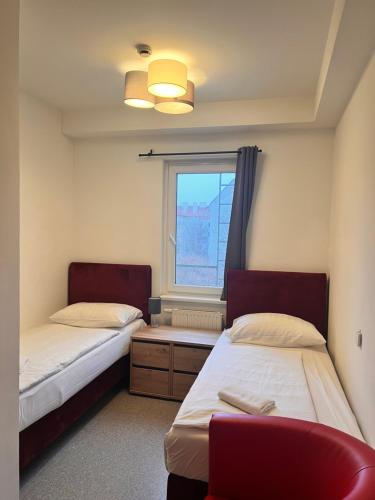 a room with two beds and a window at Hotel Astral Vienna in Vienna