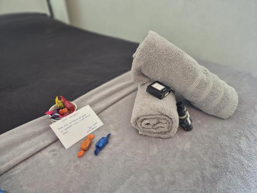 a towel and other items on a bed at Juan Plage in Juan-les-Pins