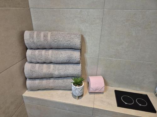 a stack of towels on a shelf in a bathroom at Juan Plage in Juan-les-Pins