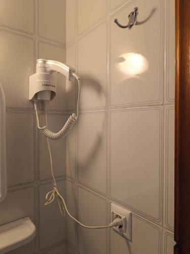 a blow dryer on the wall of a bathroom at Fotini's Beach in Olympic Beach