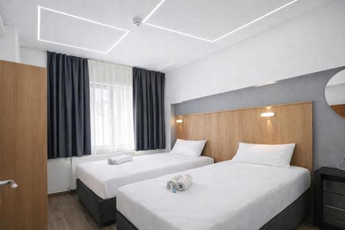 a hotel room with two beds and a window at Kilic Boutique Hotel in Istanbul