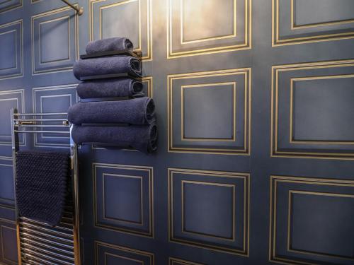 a stack of towels on a towel rack in a room at The Barley Silo in Ipswich