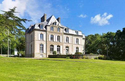 a large house with a grassy field in front of it at ZEcamping 3 étoiles pet friendly piscine chauffée et piscine couverte in Audierne