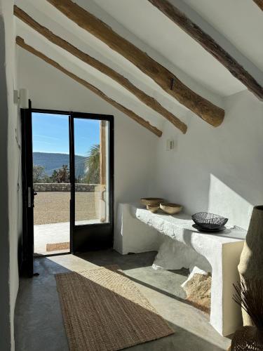 a room with a door open to a patio at Casa Horizonte in Iznájar