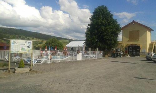 a fence in front of a building with a tree at ZEcamping 3 étoiles dog friendly piscine chauffée en bordure de l'Allier in Lespéron