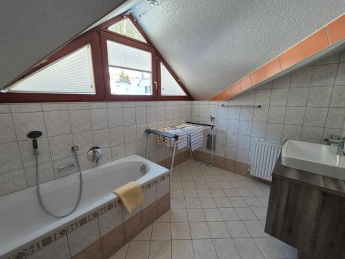 a bathroom with a bath tub and a sink at Haus Gande in Spiss