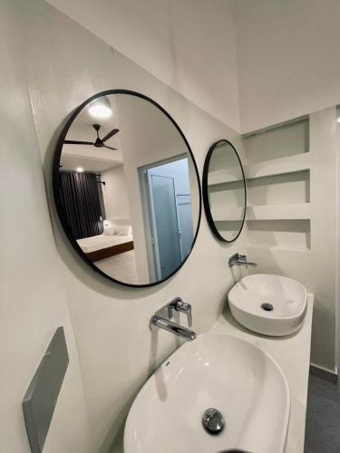 a bathroom with a white sink and a mirror at LaRoy -Mirissa in Mirissa