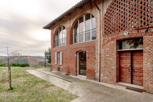an old red brick building with a garage at La Trifola in Scurzolengo