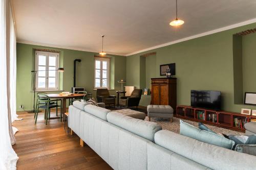 a living room with a large couch and a table at La Trifola in Scurzolengo