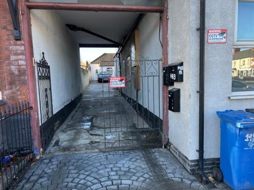 an alley way with a gate and a sign on it at Spacious Double Room Close to Derby City Centre in Derby