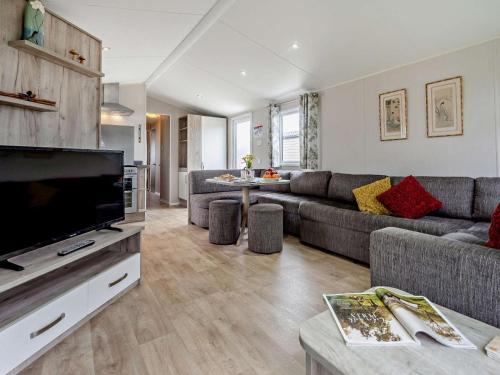a living room with a couch and a flat screen tv at 3 Bed in Ventnor oc-94278 in Rookley