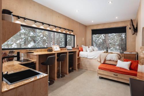 a bedroom with a bed and a desk at Domaine FORESIA in Saint-Alexis-des-Monts