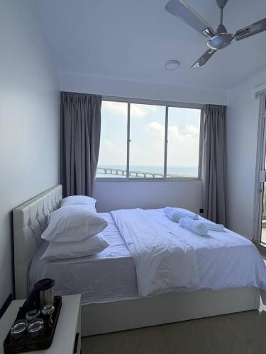 a bedroom with a white bed with a large window at Park View Stay in Male City