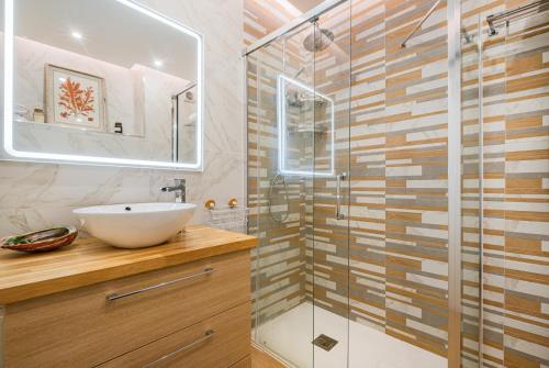 a bathroom with a sink and a glass shower at Jardins Vale de Parra in Albufeira