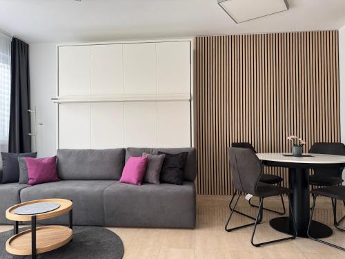 a living room with a couch and a table at Ascona Principessa Apt 3 in Ascona