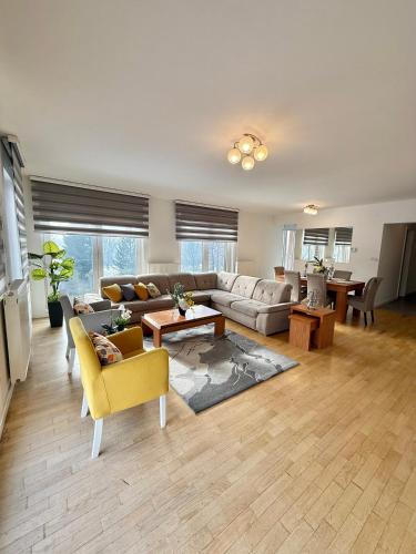 a living room with a couch and a table at Ilidza River Apartments in Sarajevo