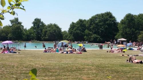 a group of people laying on the grass at a park at ZEcamping 3 étoiles animaux acceptés sauna piscine couverte in Mont-près-Chambord