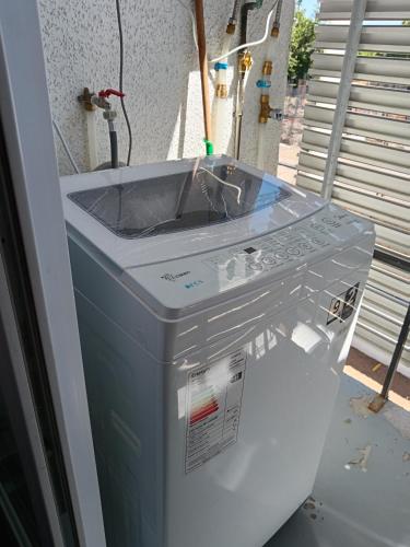 a washing machine is sitting in a room at Departamento, Chillan in El Cerrillo