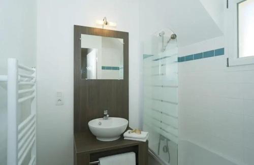 a white bathroom with a sink and a mirror at ZEcamping 3 étoiles pet friendly piscine chauffée et piscine couverte in Audierne