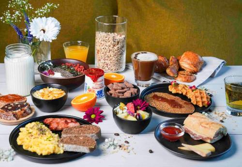 a table with many different types of breakfast foods at B&B HOTEL Brumath Bernolsheim in Brumath