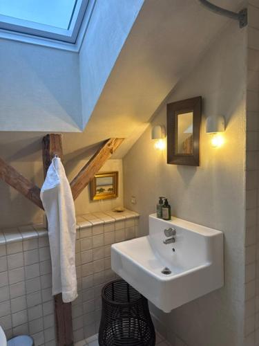 a bathroom with a sink and a ceiling at Lysbjerggård Bed & Break Herning in Herning