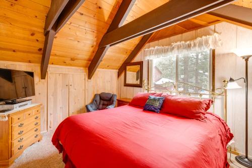 a bedroom with a red bed in a wooden room at Discount Available! Lake Tahoe Gem w/ Pool Table in South Lake Tahoe