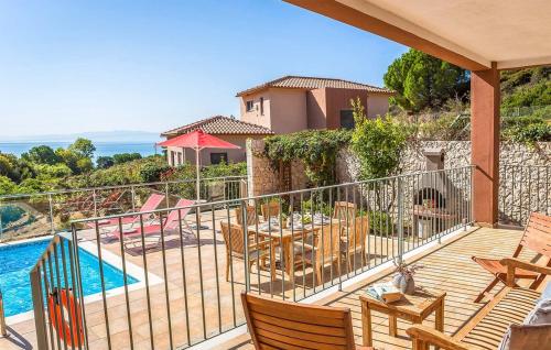 a balcony with a table and chairs and a pool at Villa Giorgio by Villa Select in Kefallonia